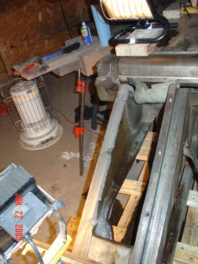View of infeed sled base with stay missing.